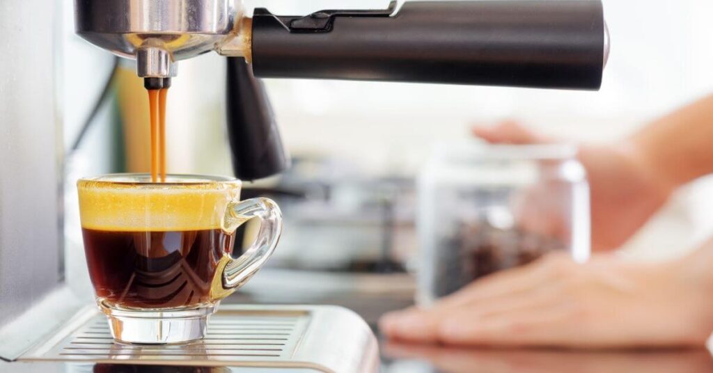 Espresso coffee coming out of an espresso coffee machine 