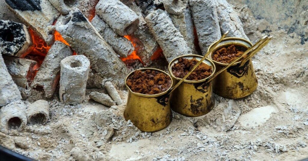 Turkish coffee pots close cooking coffee on charcoal 